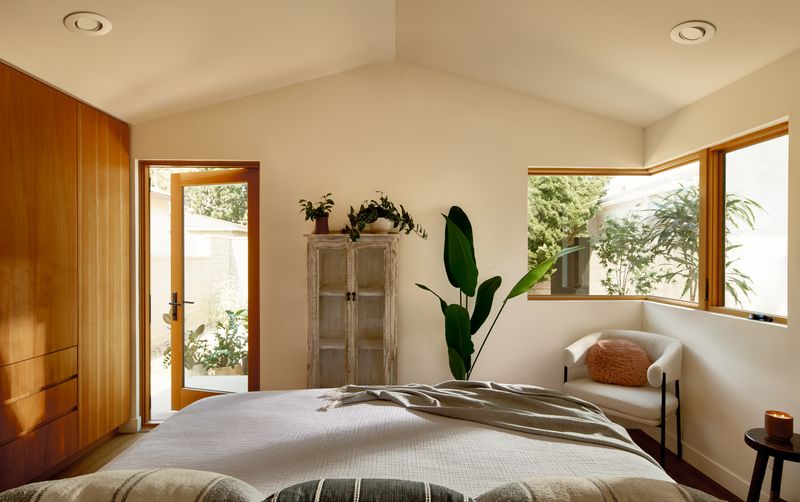 Warm-toned wooden door connecting interior and exterior spaces with seamless indoor-outdoor flow in Japandi style