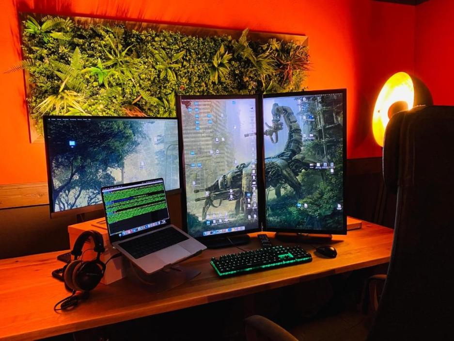 Completed DIY artificial green wall panel installed above desk in home office setting