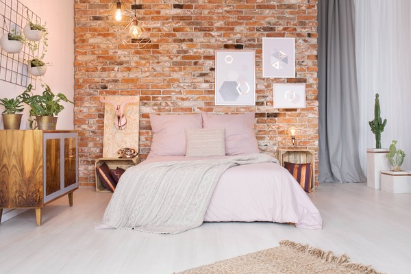 White brick effect PVC panels creating urban industrial feature wall in bedroom with plants