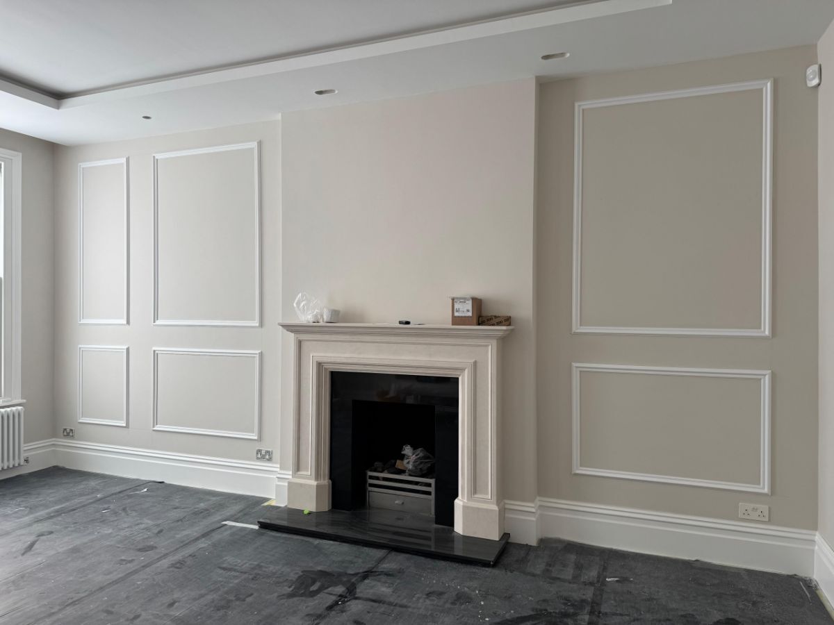 Media wall in progress showing the framework of panel moulding with space left for television above fireplace