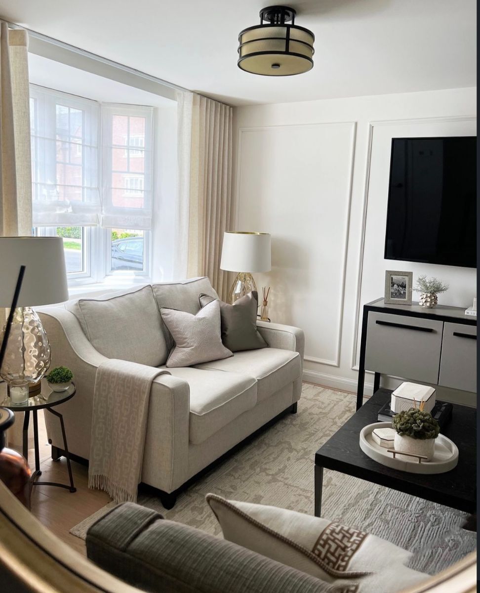 Living room area with the same single row panel moulding rectangles on the TV wall, showing a cohesive design throughout the home