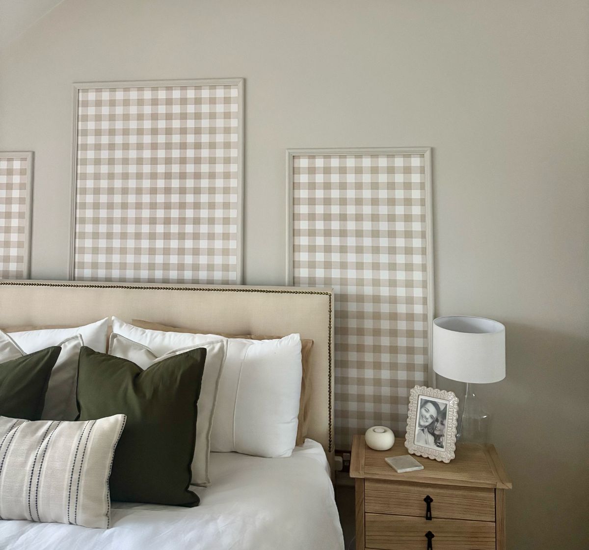 Straight-on view of the bedroom wall with panel moulding frames containing a checkered pattern, showing the full effect of the design