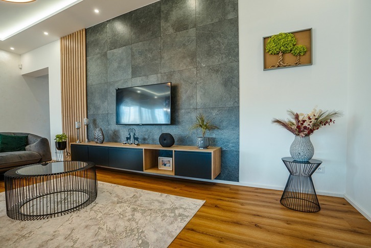Stone-slate media wall with floating console in a modern living room.