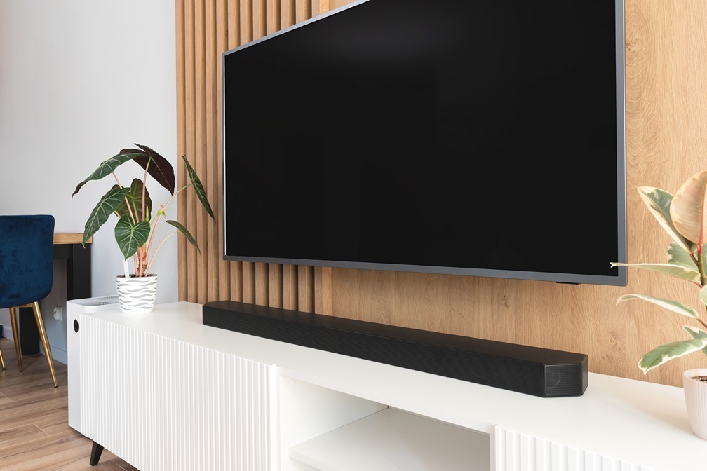 Timber-slatted media wall paired with a white ribbed console cabinet.