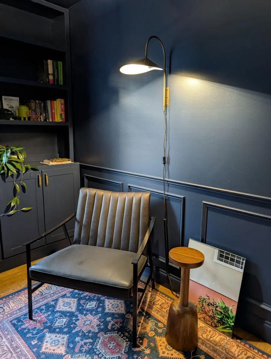 Mid-century inspired room with navy blue half-wall wainscoting