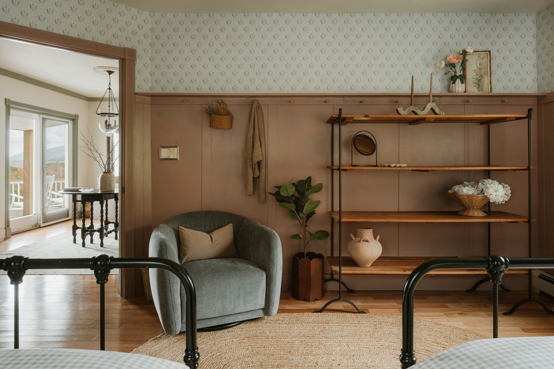 Traditional board and batten panelling painted in warm tan with floral wallpaper above