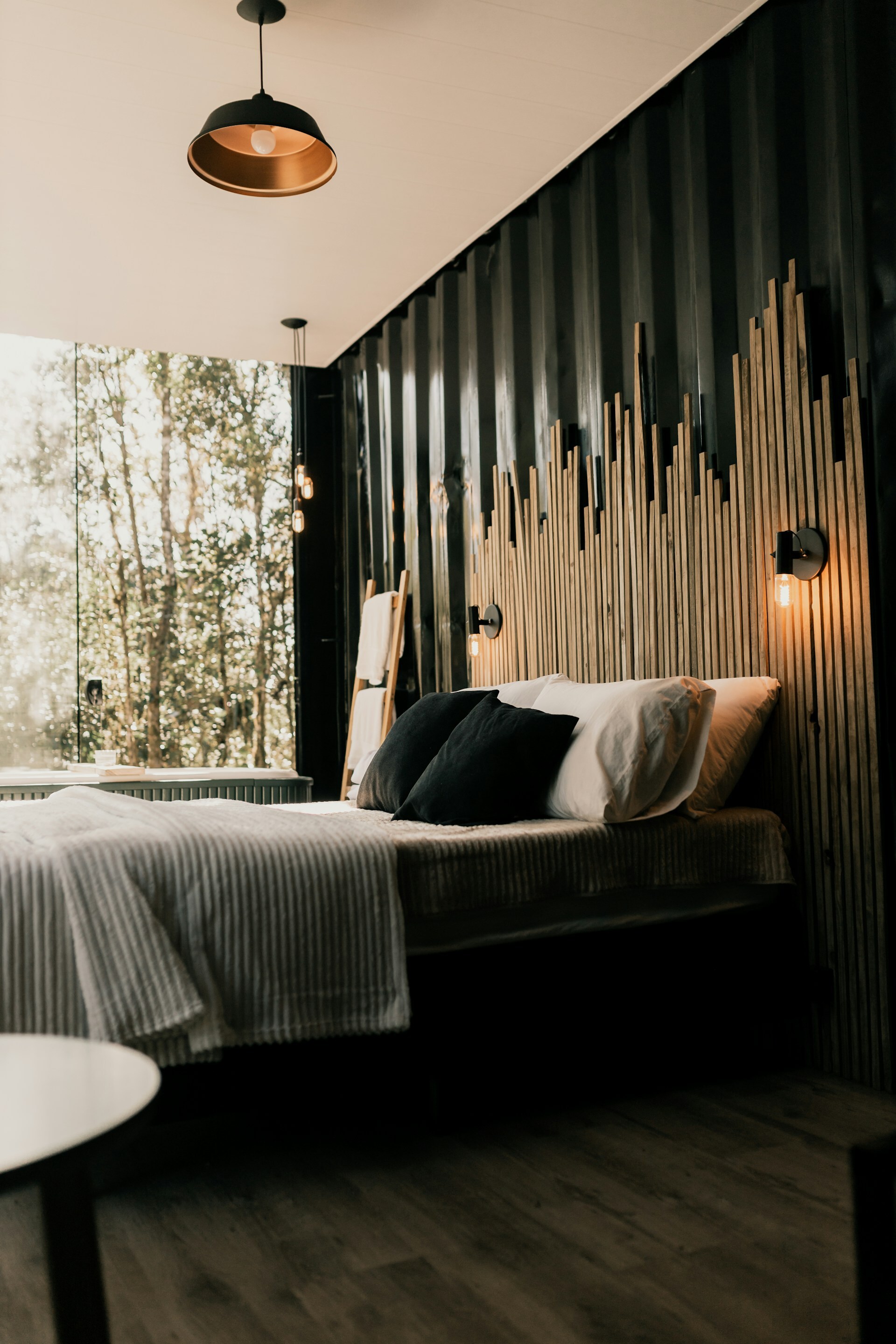 Natural wood slat panel feature wall with varied lengths creating architectural interest