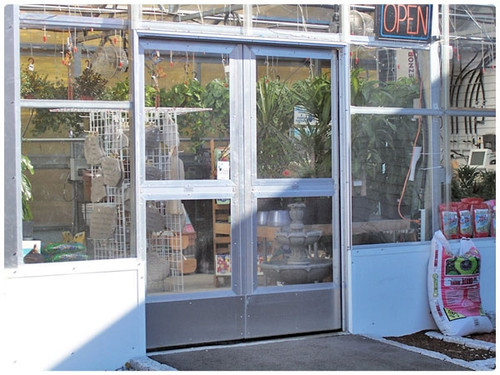 Double sliding greenhouse doors with glass panels