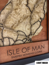 The layers are laser cut from different woods, each selected to add contrast and warmth to the piece. The front title layer and sea below are engraved mahogany or Walnut. The road course is engraved with a thin racing stripe and pops out brightly from the background levels.