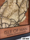 The layers are laser cut from different woods, each selected to add contrast and warmth to the piece. The front title layer and sea below are engraved mahogany or Walnut. The road course is engraved with a thin racing stripe and pops out brightly from the background levels.