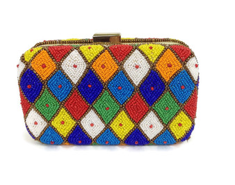 A wardrobe Must have, this Mexican Box clutch will go with most dresses. Featuring Amazing hand beaded pattern of diamonds , it has a long carry chain.