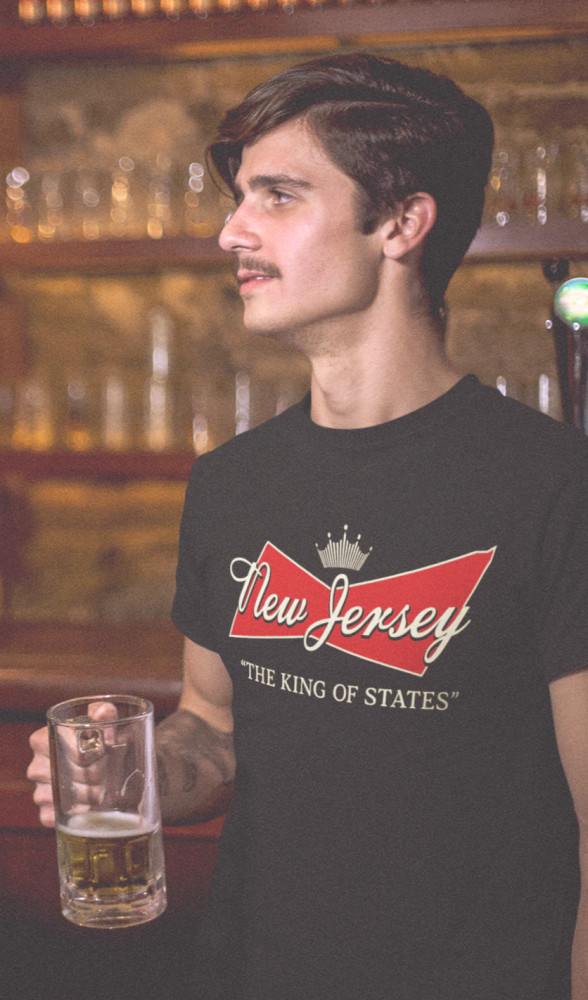 The old Budweiser logo may not adorn the Newark skyline anymore, but never doubt for a moment who truly wears the crown. Cheers to New Jersey - the true king of the states!

Made from pre-shrunk ring-spun cotton for an ultra soft feel and it fits like a standard band tee; not too snug and not too baggy with straight sides for a little bit of looseness in the shoulders and waist. Suitable for wearing out on the town or lounging around the homestead.