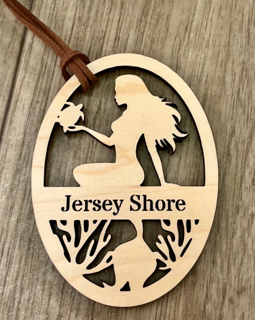 The ornament is approximately 3.25” x 2.75” on a suede cord for hanging. The natural color of the wood will vary depending on the natural grains and color of the wood. 