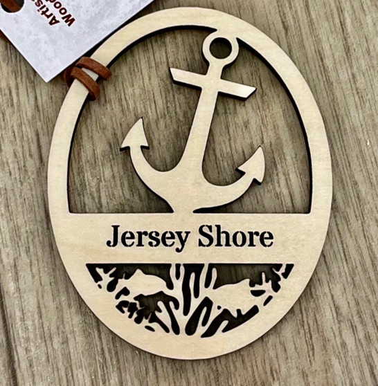 The ornament is approximately 3.25” x 2.75” on a suede cord for hanging. The natural color of the wood will vary depending on the natural grains and color of the wood. 