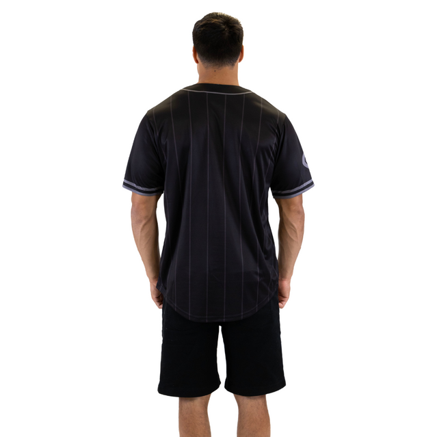 Side view of the Carlton Men's Blackout Baseball Shirt worn by a model.