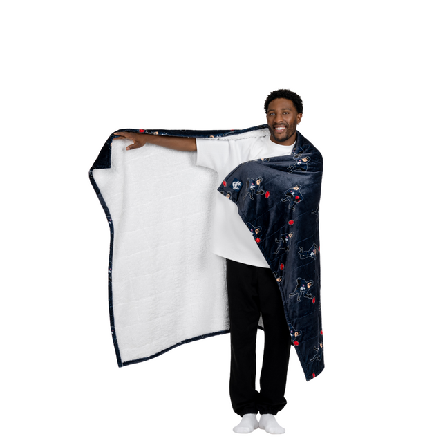 Lifestyle image of the Carlton Oodie Blanket used on a couch.