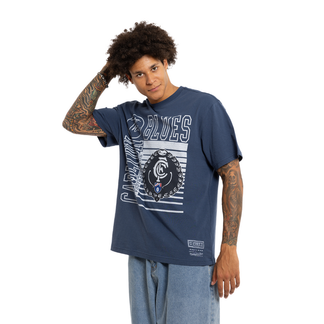 Lifestyle front shot of the Carlton Blues Emblem Tee worn by a model.