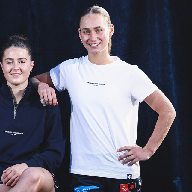 Front view of the white Carlton Women's Signature Tee by NAR worn by a model.
