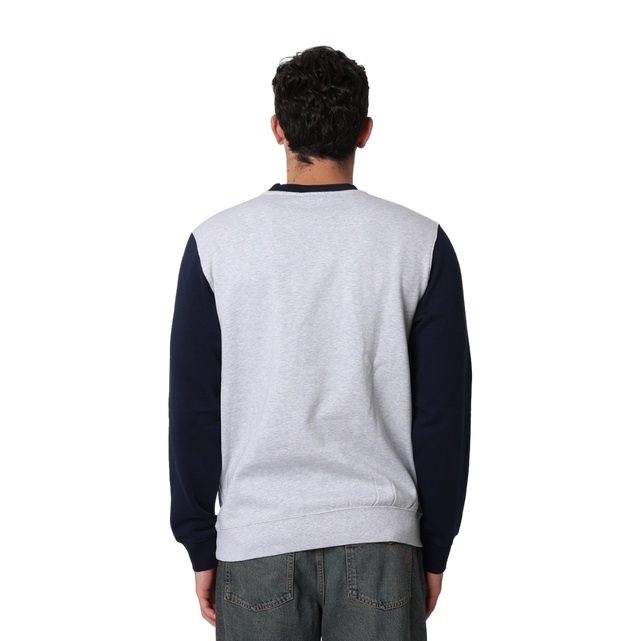Side view of the Carlton Adults Varsity Oversized Crew sweatshirt worn by a model.