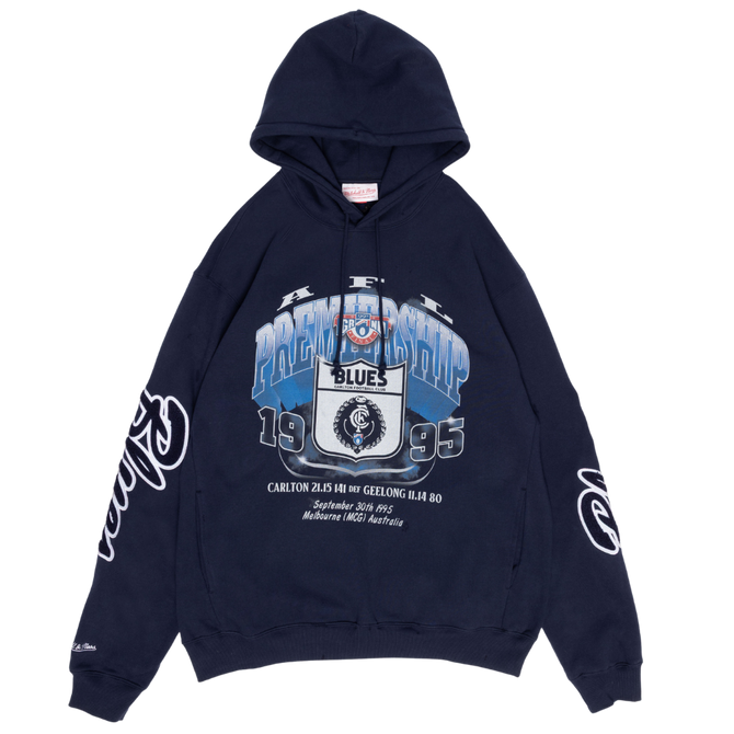 Front view of the Carlton '95 Premiership Hoodie by Mitchell & Ness, worn by a model.