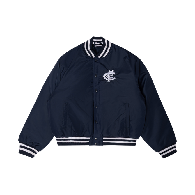 Front view of the navy Carlton Women's Monogram Bomber Jacket by NAR worn by a model.