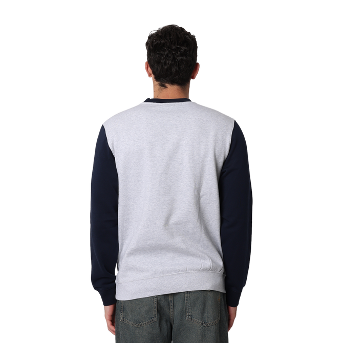 Side view of the Carlton Adults Varsity Oversized Crew sweatshirt worn by a model.