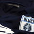 Close-up of the woven Carlton monogram logo on the VFL Wool Guernsey.