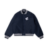 Front view of the navy Carlton Women's Monogram Bomber Jacket by NAR worn by a model.