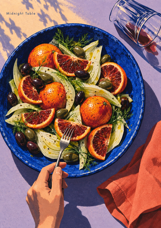 Overhead view of blood oranges, fennel and olives in a cobalt bowl, with a hand holding a fork, a tipped glass and coral napkin.