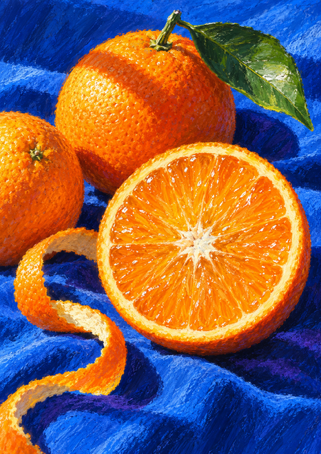 Two whole oranges and a cut orange half with a green leaf and curling peel on bright blue cloth.