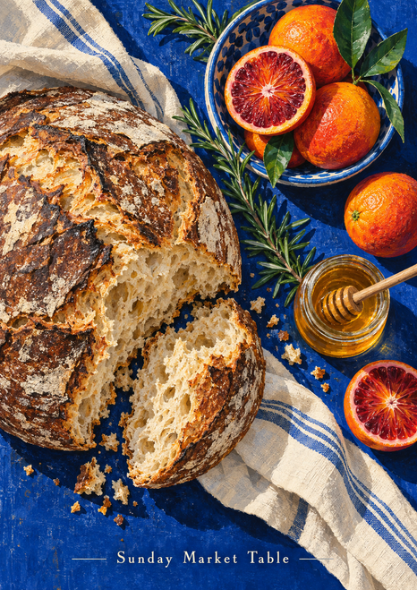 Overhead still life of rustic bread, blood oranges, honey, rosemary and blue-striped linen with the title Sunday Market Table.