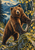 A large brown bear stands beside a fallen birch trunk and mossy boulder, with forest, lake and mountains behind it.