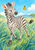 A young zebra turns toward a yellow-orange butterfly above tall blue-green grasses, with a bright sky and distant trees.