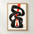 Black looping ribbon-like sculpture around a vermilion vertical strip, with four orange-red discs on warm off-white.; frame shown for styling only