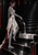 Red-haired dark elf in white pouring a silver stream from a black pitcher to form a step on a glossy dark staircase.