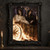 Two crowned winged figures in pale and black robes sit in a gold chariot beside flames beneath a dark sun.; frame shown for styling only