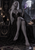 White-haired elf sorceress in a black gown raises violet smoke near a black cat, books and candles.