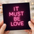 IT MUST BE LOVE Neon Typography Greeting Card - Love & Anniversary Card for Partner, Girlfriend or Boyfriend - Modern Pink Lettering, Blank Inside