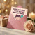 Funny Birthday Card for Partner - 'Happy Birthday to My Not So Innocent Angel' Cute Devil Character with Trident and Balloon, Heart Pattern