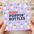 Poppin' Bottles New Baby Greeting Card - Funny Baby Bottle Design - Congratulations Card for New Parents or Shower - Purple