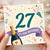 27th Birthday Card, Colourful Celebration Card with Champagne Bottle and 'It's Your Birthday!'
