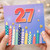 27th Birthday Card, Colourful Candles and Fireworks Design