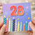 28th Birthday Card, Colourful Candles and Fireworks Design
