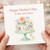 Mother's Day Card for Nana - Floral Cake Illustration with 'Happy Mother's Day To the Best Nana' - Elegant Watercolour Style, With Love Tag - Grandmother/Nana Card