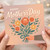 Happy Mother's Day Card - Hand Holding Floral Bouquet Illustration on Warm Pastel Background - For Mum