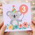 Koala 3rd Birthday Card - Cute Party Hat Koala with Number 3 Balloon, Pastel Flowers & Confetti - Child's Third Birthday