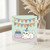 Funny Rude Birthday Card - Cat with Party Hat, Pastel Bunting ‘HAPY BIRHDAY’ and Cake Saying ‘NOB’ - Cheeky Humour for Friends