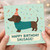 Funny Sausage Dog Birthday Card - Dachshund in Party Hat & Jumper with Confetti - 'Happy Birthday Sausage!' Pun Card for Dog Lovers