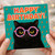 Funny Cat Birthday Card - Black Cat with Colourful Polka-Dot Glasses on Teal with Lightning Bolts - Happy Birthday