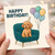 Happy Birthday Card - Cute Poodle Dog on Teal Armchair with Balloons & Party Hat - For Dog Lovers, Friends & Family